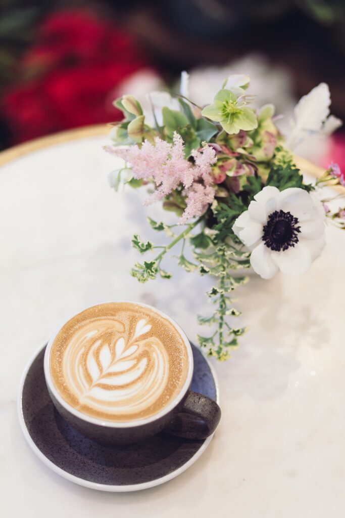 Hygge-style place setting with coffee and flowers