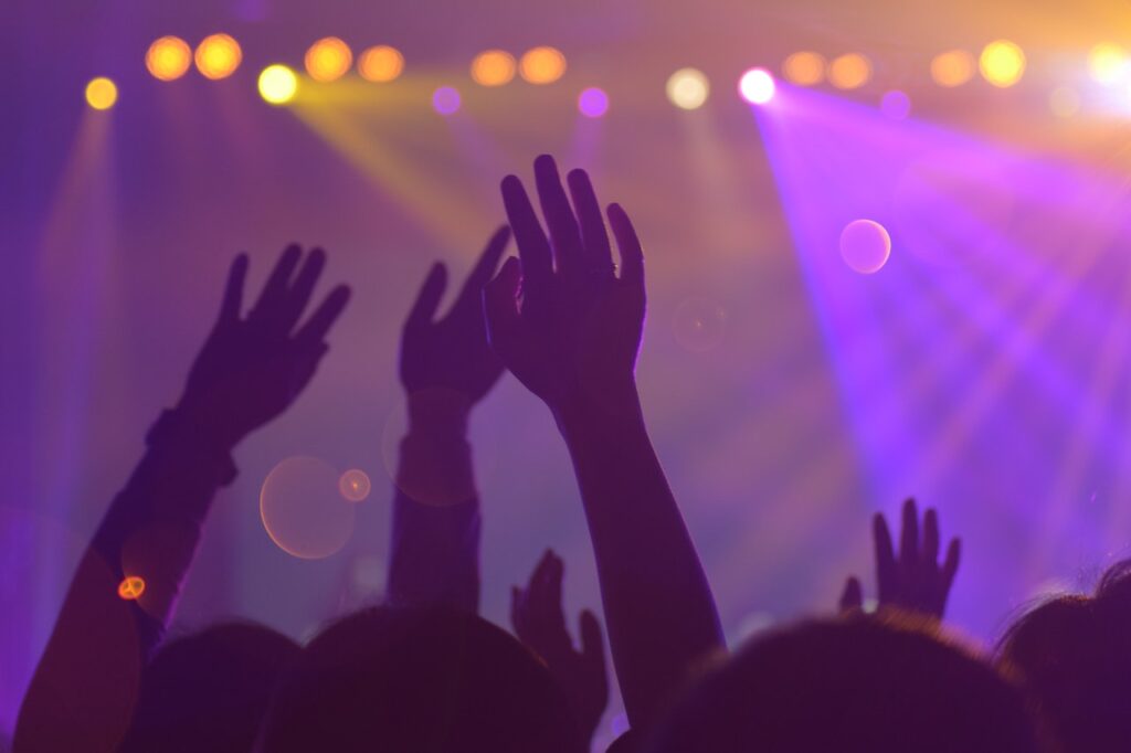 People at concert with hands in the air