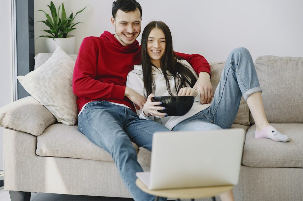 Couple watching movie. Indoor adult activities