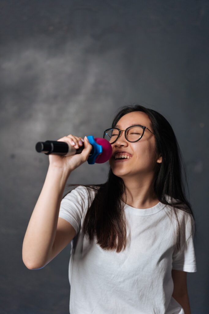 Girl happily singing in microphone