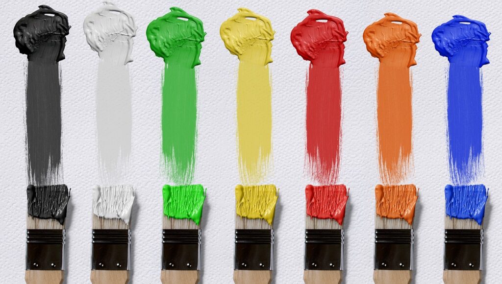 Spectrum of colored paint and paint brushes