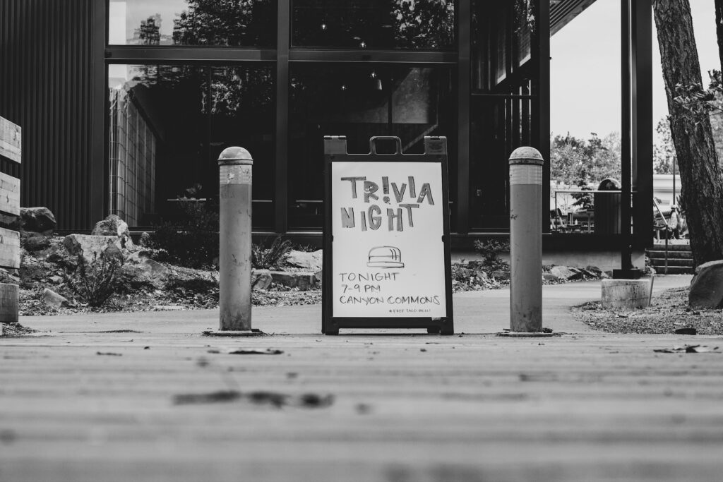 Black and white photo with trivia night sign