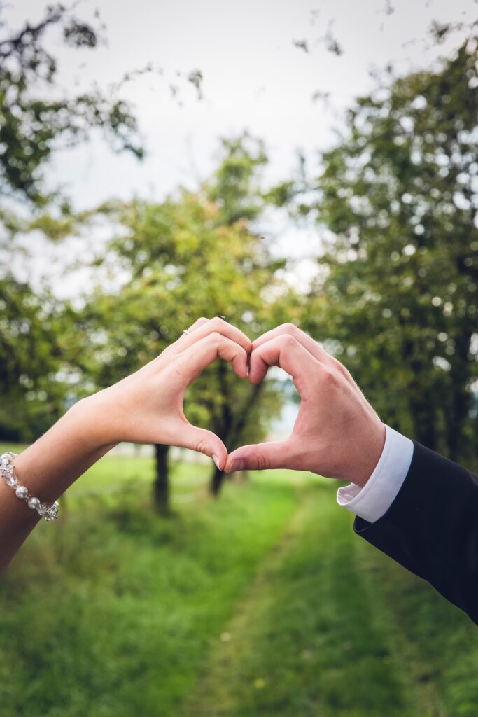 Couple's hands making heart shape