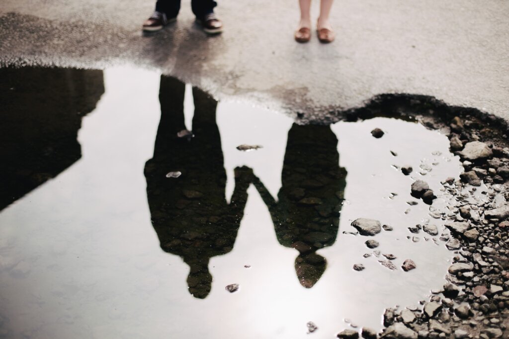 Couple holding hands reflection 